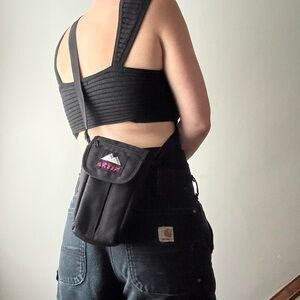 Black Artix sporty camera bag with pink and white logo